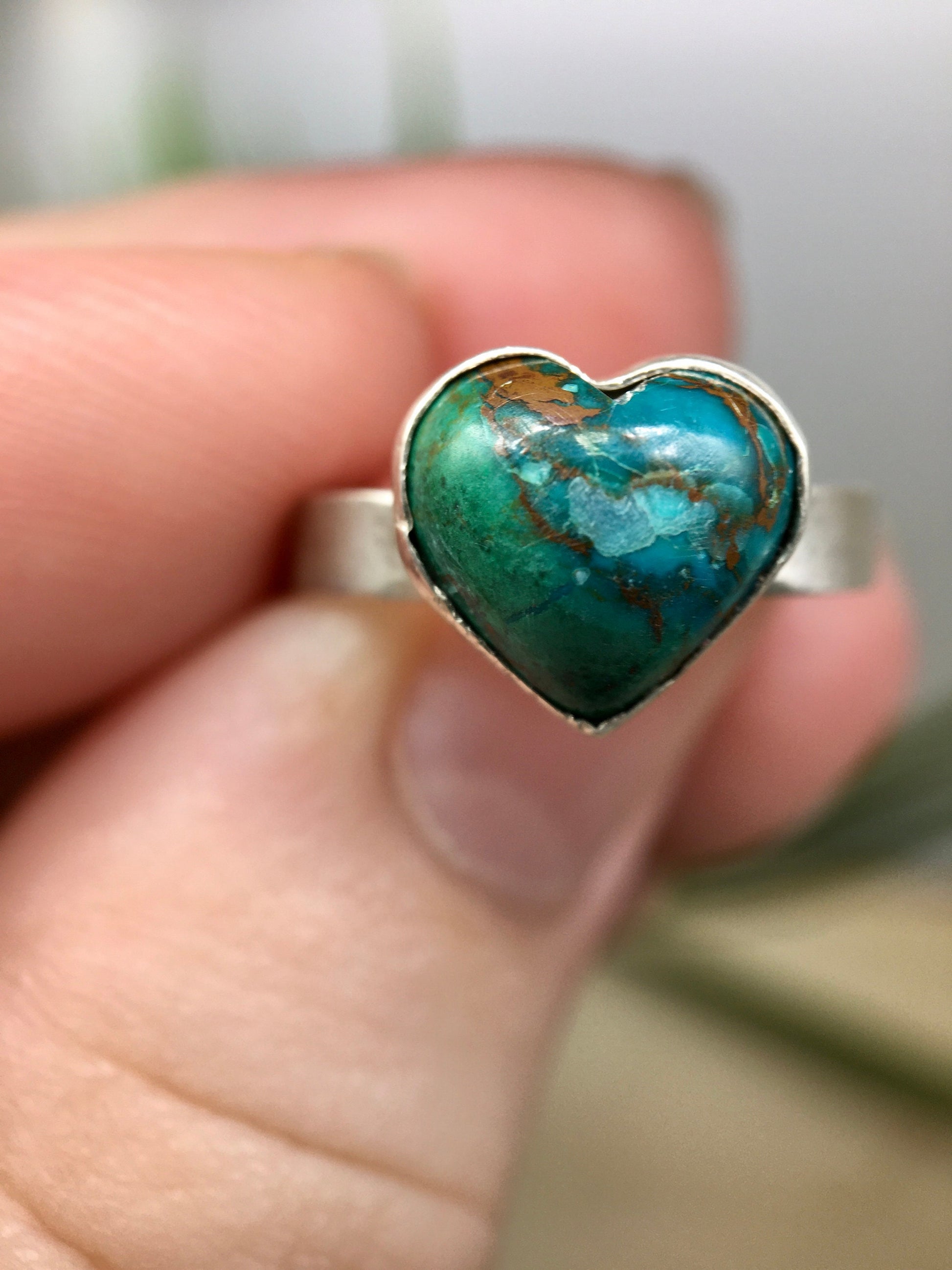 Sterling silver ring with a heart-shaped blue-green chrysocolla gemstone.